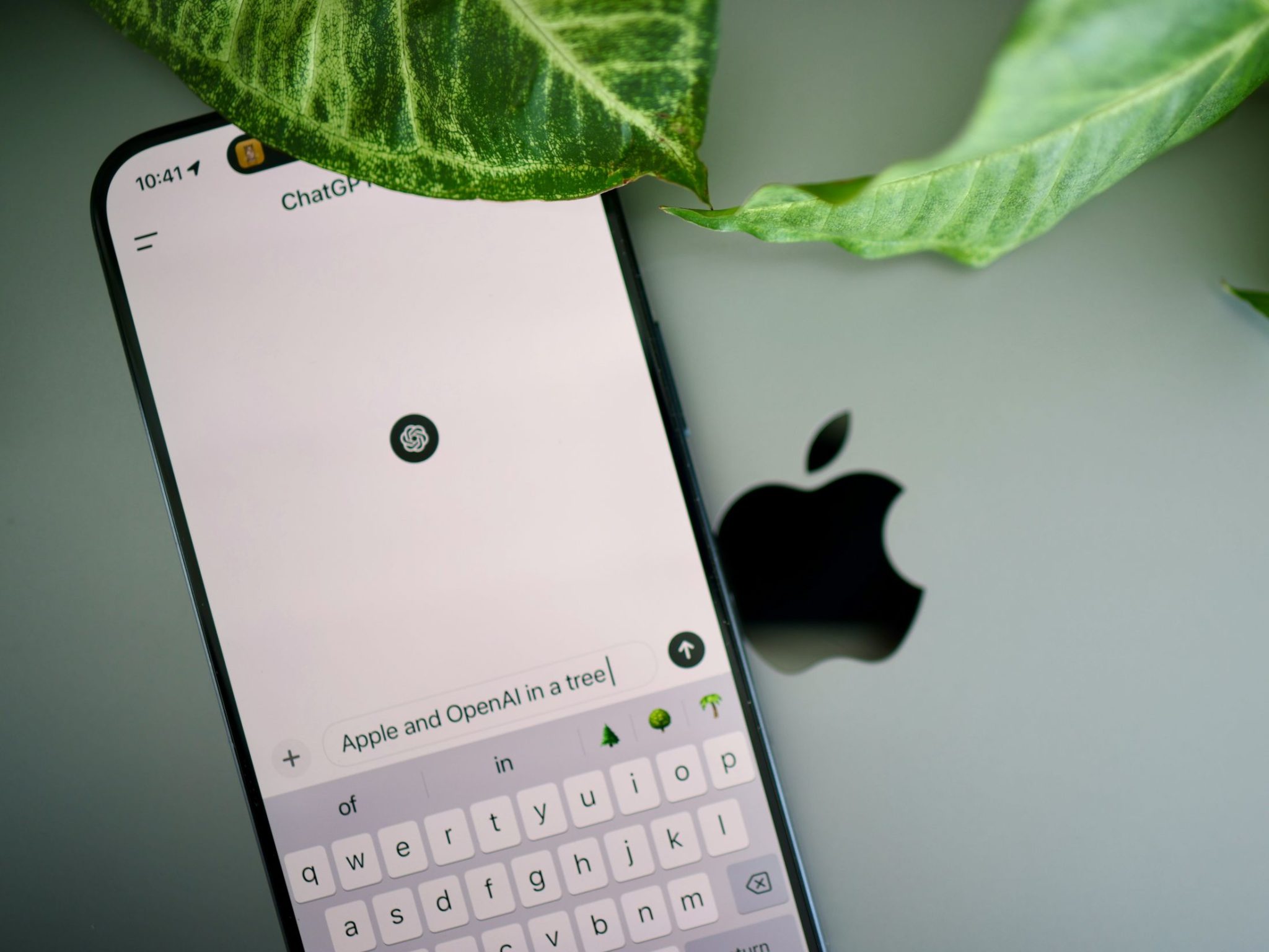 ChatGPT iOS app on iPhone with the Apple logo in the background as OpenAI is deploying a Health feature inside ChatGPT, giving users the option to connect Apple Health data and medical records to the chatbot.